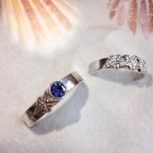 Hammered silver ring featuring a delicate silver starfish and a tanzanite cubic zirconia
