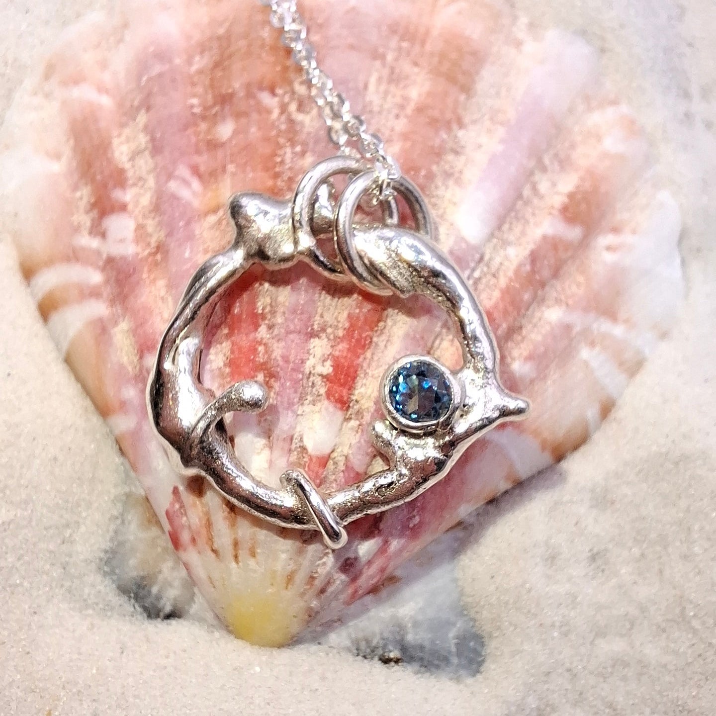 Silver seafoam-inspired handmade pendant and necklace set with a blue Swiss Topaz by Shelley Ide Jewellery.