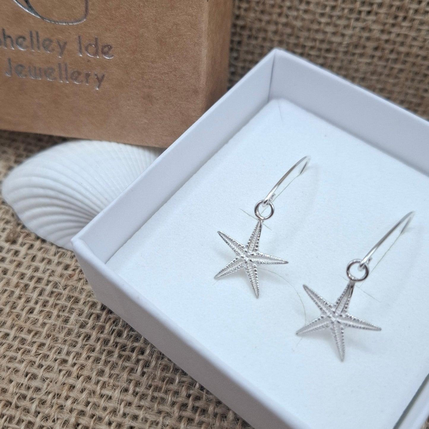 Cast silver starfish dangly earrings on a V shaped ear wire