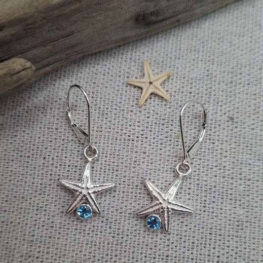 Cast silver starfish dangly earrings with swiss topaz
