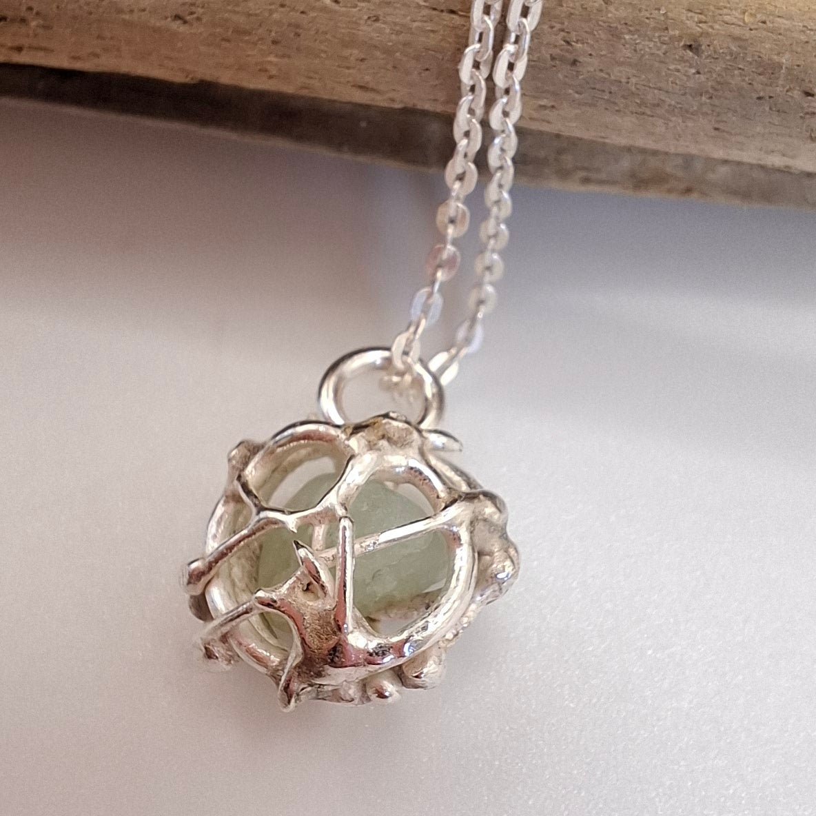 Silver bracelet featuring a tangled tides fishing net-inspired charm pendant by Shelley Ide Jewellery.