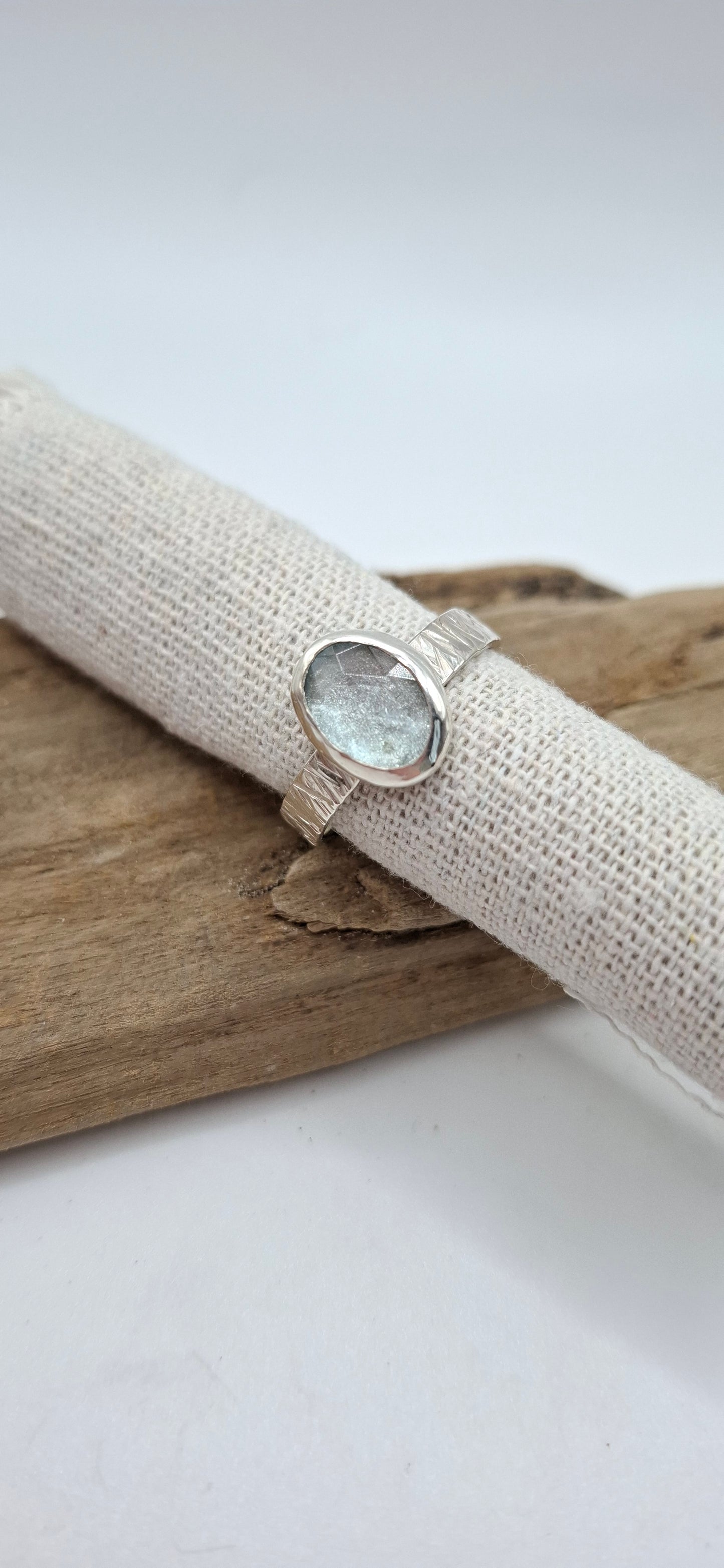 Hammered textured silver ring featuring a rose cut aquamarine