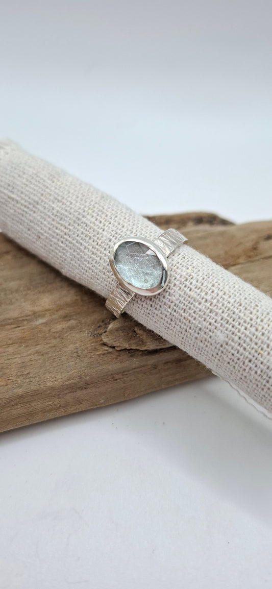 Hammered textured silver ring featuring a rose cut aquamarine