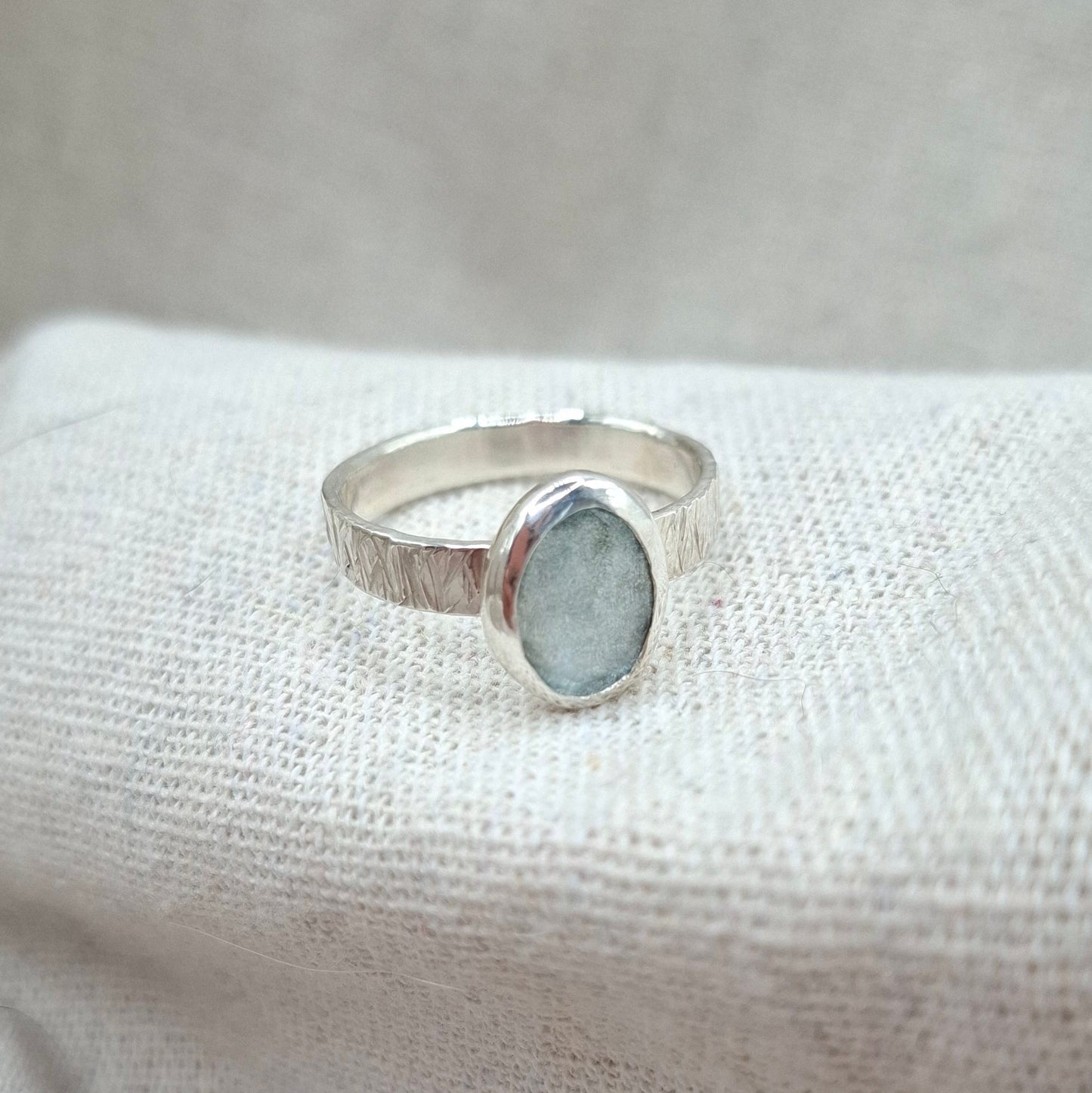 Hammered textured silver ring featuring a rose cut aquamarine