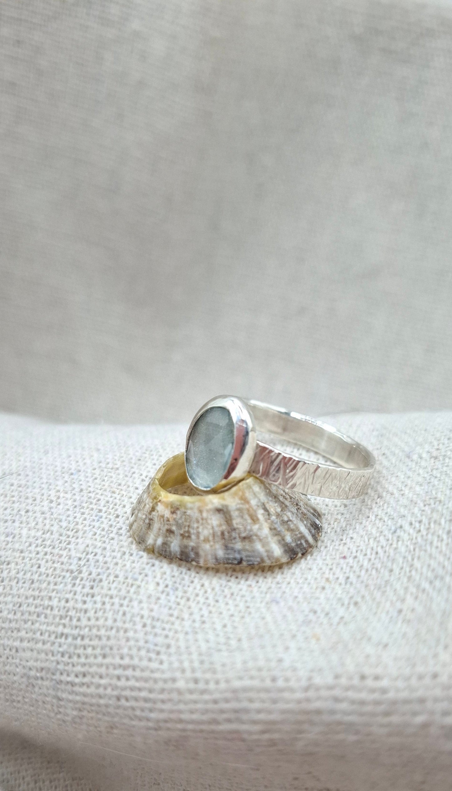 Hammered textured silver ring featuring a rose cut aquamarine