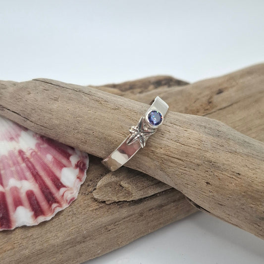 Hammered silver ring featuring a delicate silver starfish and a tanzanite cubic zirconia | Ocean-Inspired Handmade Jewellery