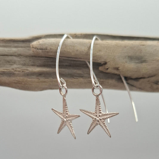 Cast silver starfish dangly earrings on a V shaped ear wire | Ocean-Inspired Handmade Jewellery