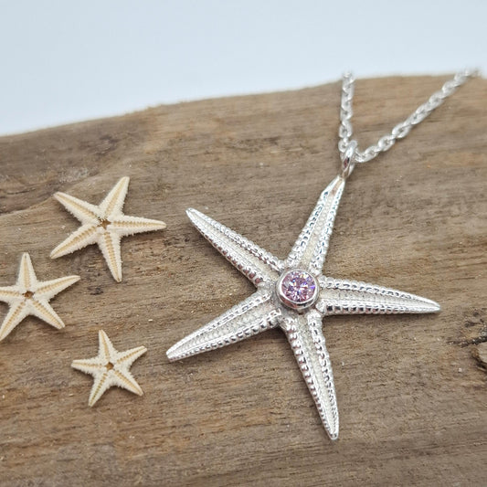 Large cast silver starfish pendant with vibrant cubic zirconia, jewelry piece from Shelley Ide Jewellery, on a chain.