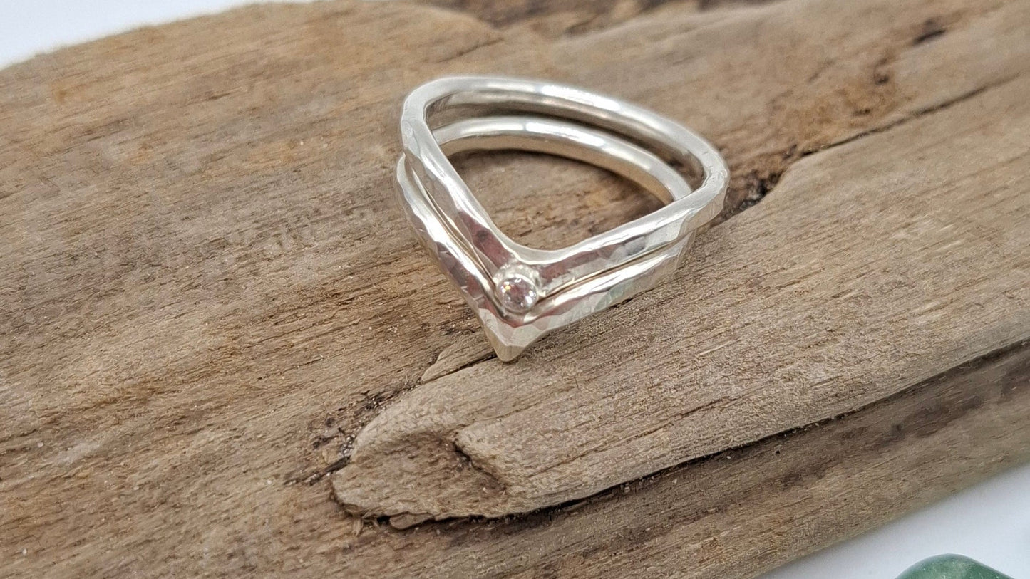 Silver stacking rings from Shelley Ide Jewellery, showcasing multiple textured and smooth bands stacked together.