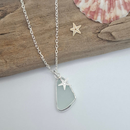 Light aqua blue seaglass pendant with silver starfish charm on a necklace by Shelley Ide Jewellery.