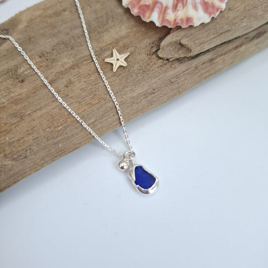 Royal blue Channel Islands Dinky seaglass pendant with silver ball charm, Shelley Ide Jewellery necklace, close-up of pendant detail.