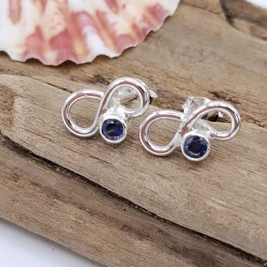 Silver infinity cubic zirconia earring studs by Shelley Ide Jewellery, featuring sparkling infinity-shaped design and secure post backs.