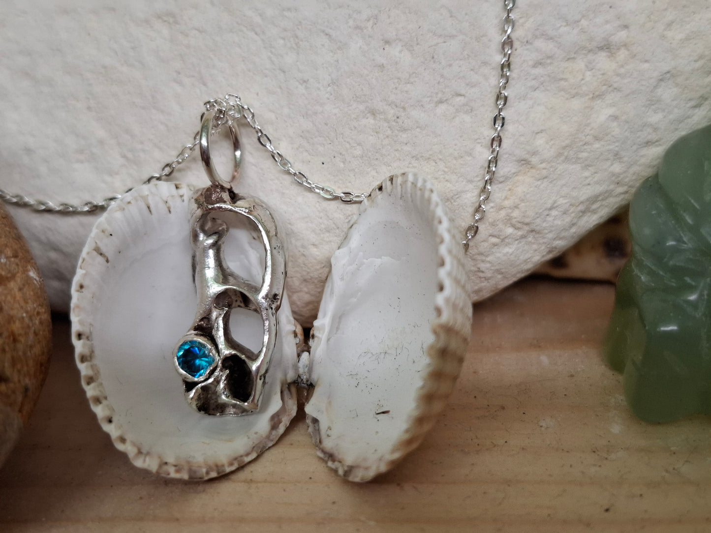 Cast silver seashell with aquamarine cubic zirconia