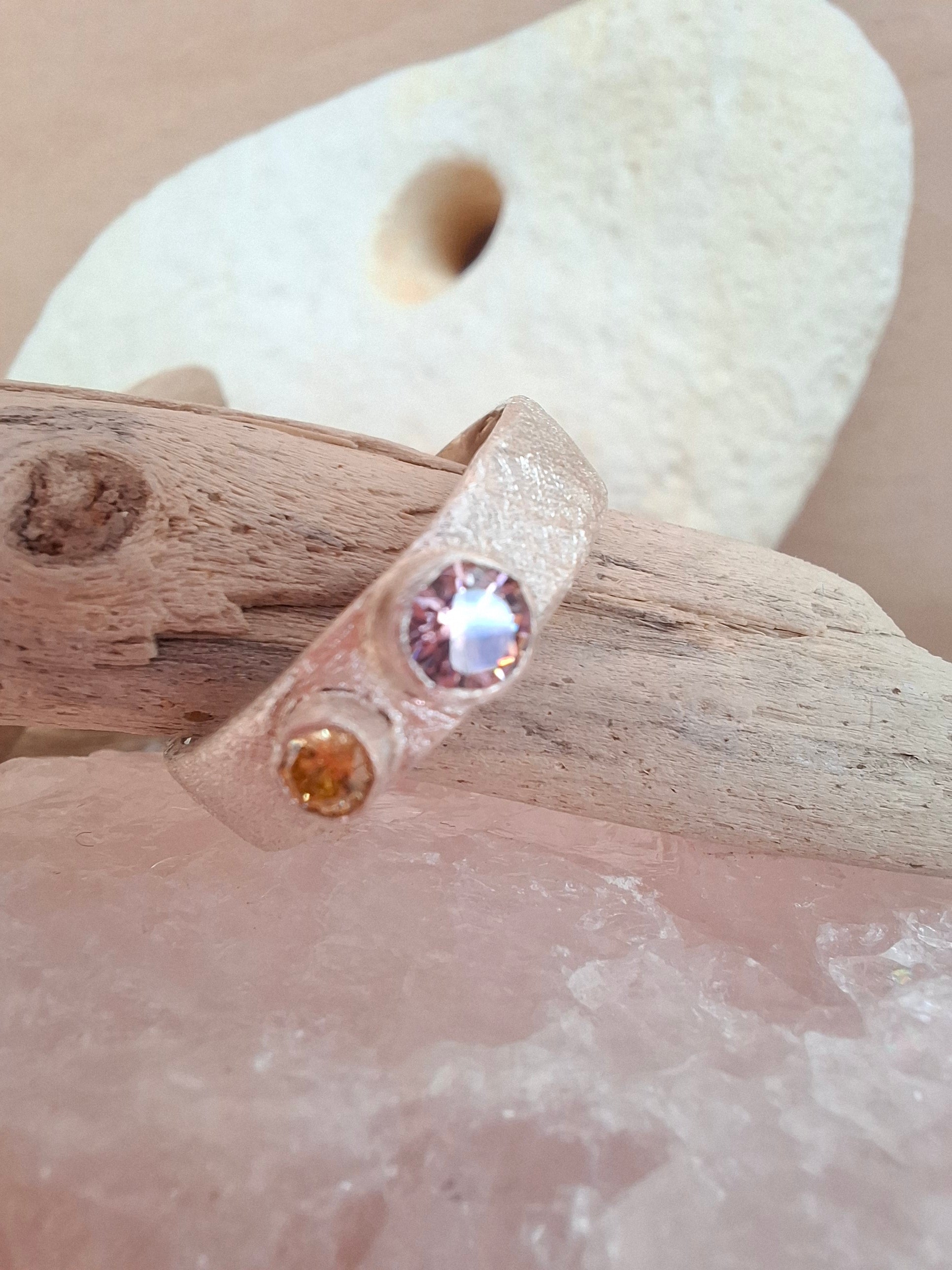 Textured silver ring with rose pink and yellow cubic zirconias.