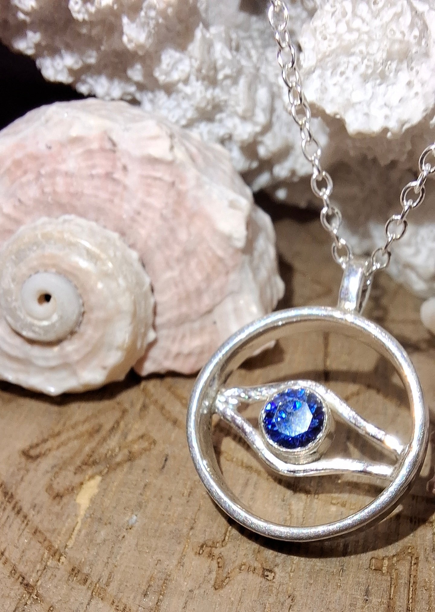 Silver and tanzanite cubic zirconia wave and evil eye circle inspired pendant