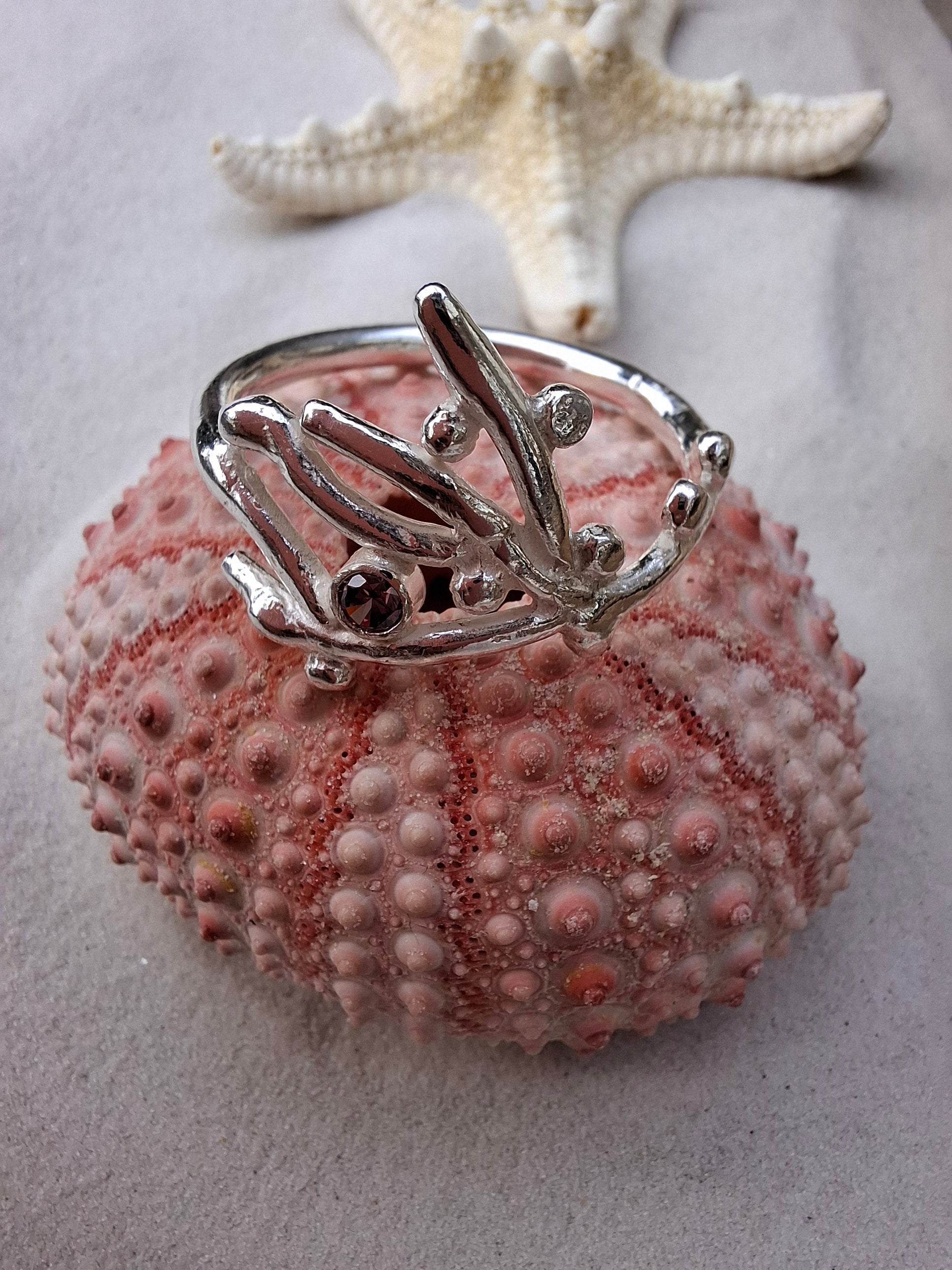 Coral inspired silver ring with a rhodolite pink cubic zirconia