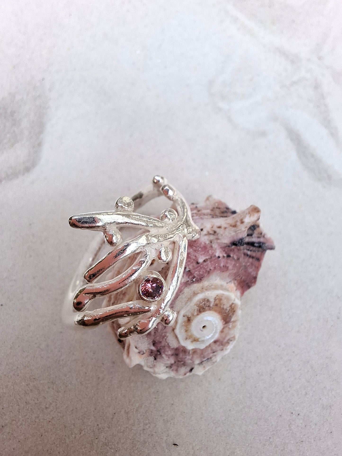 Coral inspired silver ring with a rhodolite pink cubic zirconia