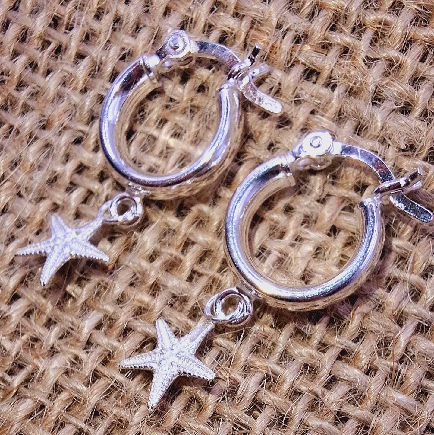 Dinky cast silver starfish on silver huggie hoop