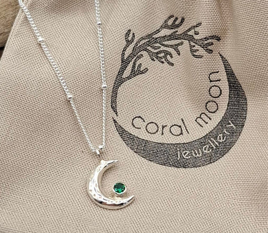 Handmade waning silver moon pendant with birthstone.
