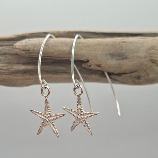 Cast silver starfish dangly earrings on a V shaped ear wire | Ocean-Inspired Handmade Jewellery