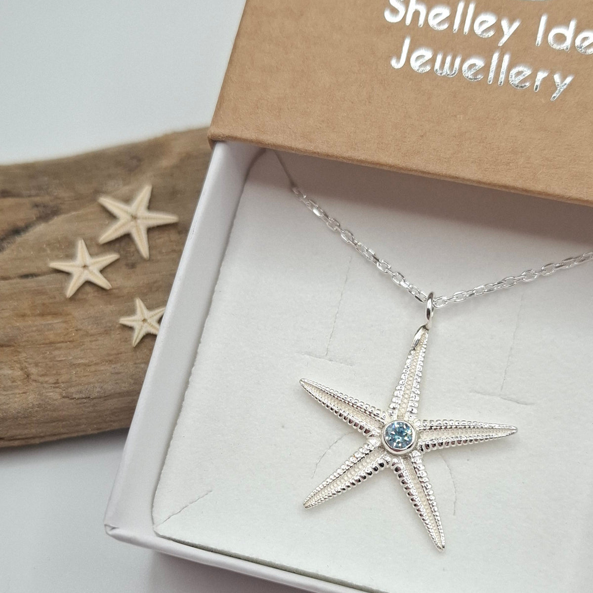 Large silver starfish pendant with vibrant cubic zirconia, featuring intricate details, part of Shelley Ide Jewellery's necklace collection.