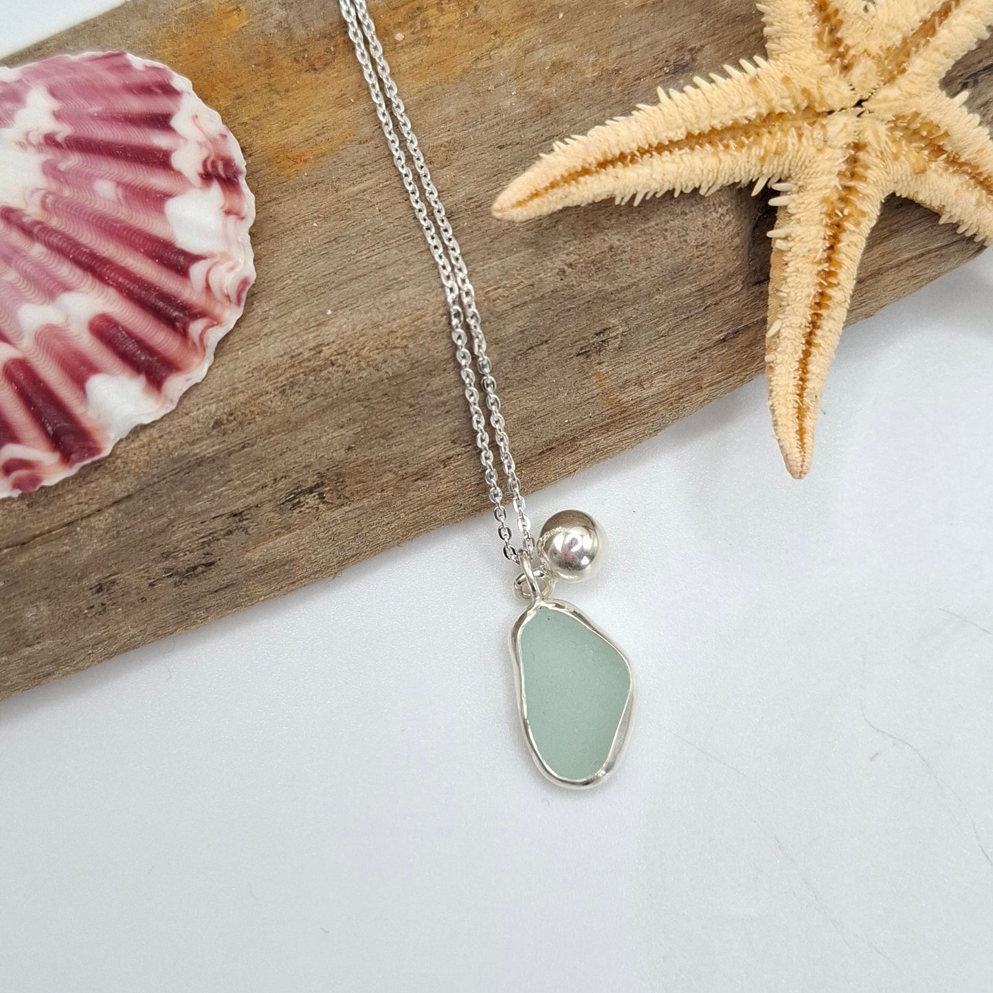 Channel Islands Aqua Blue Seaglass pendant with silver ball charm necklace by Shelley Ide Jewellery, featuring a vibrant seaglass centerpiece.