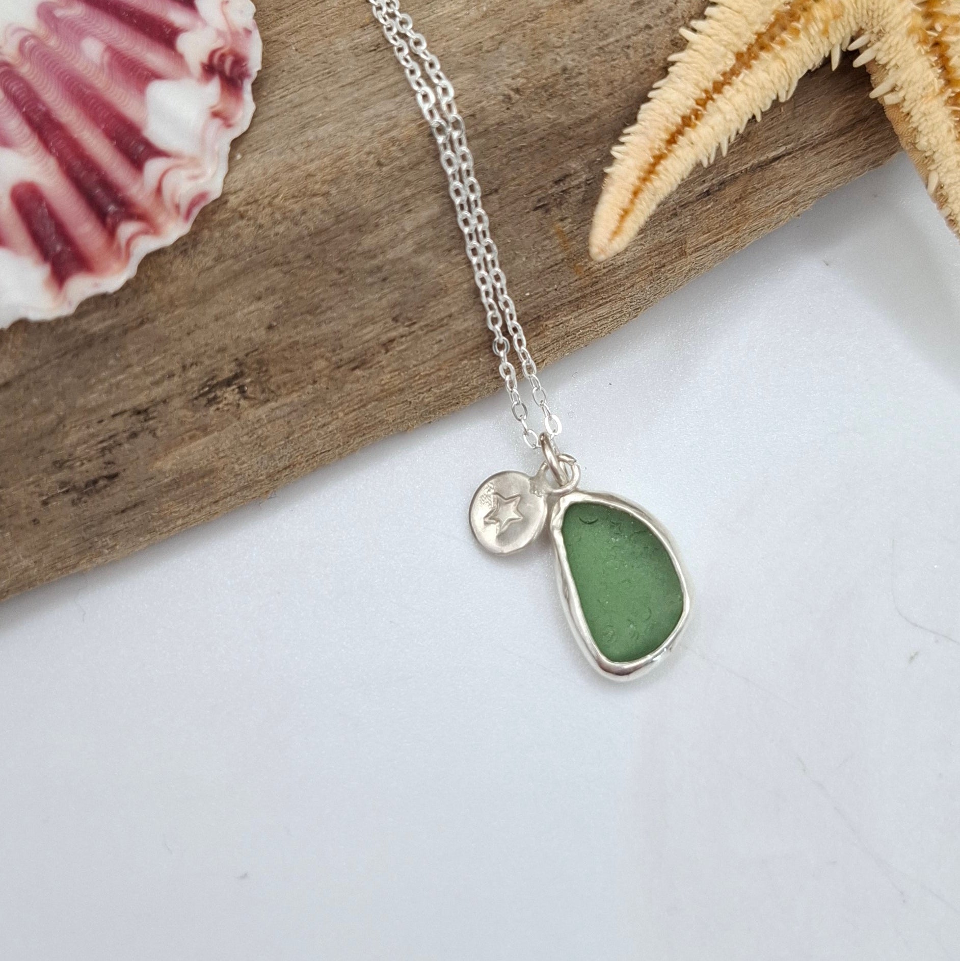 Channel Islands Green Seaglass pendant with silver star charm, featured on a Shelley Ide Jewellery necklace.