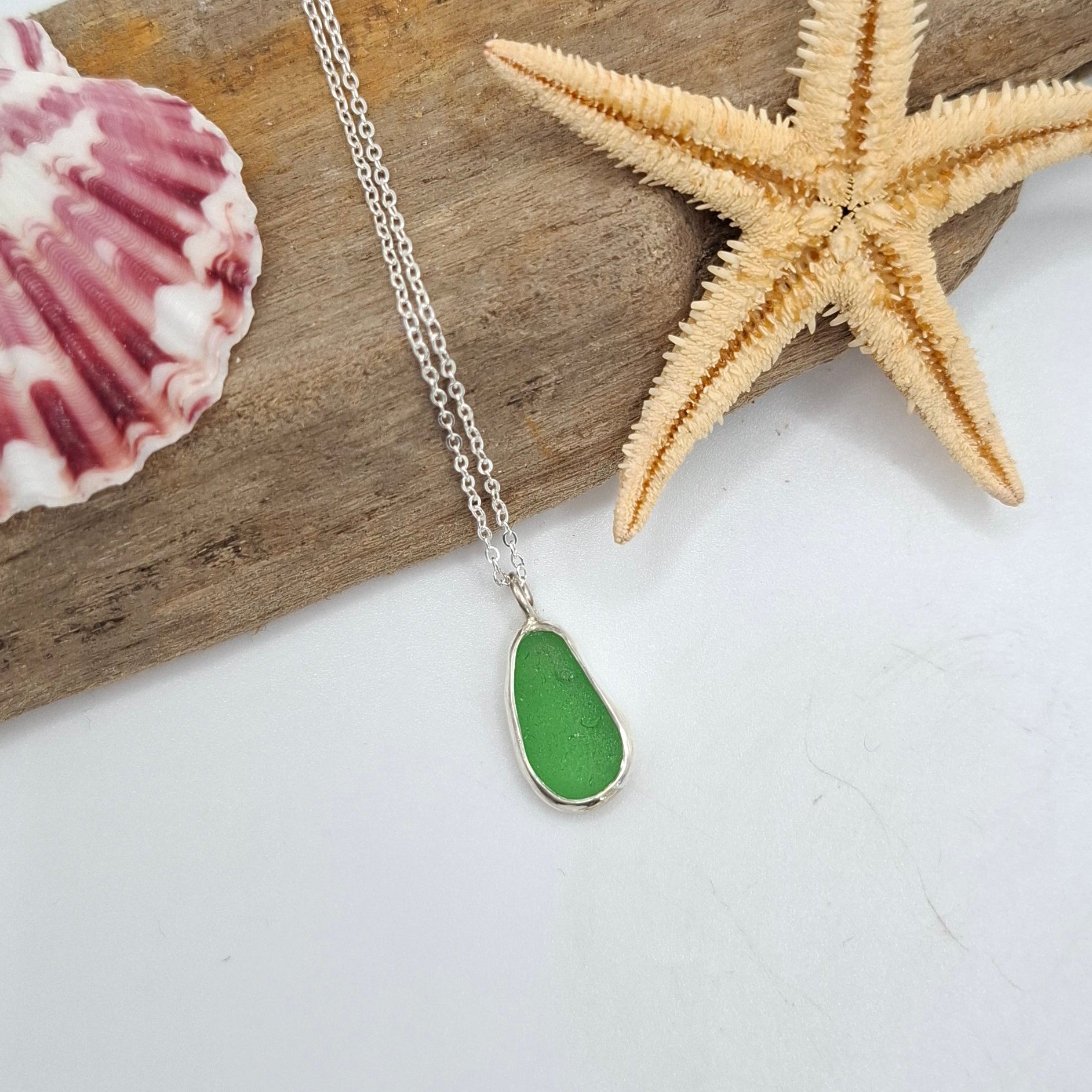 Bright green seaglass pendant on a necklace by Shelley Ide Jewellery, showcasing a smooth, polished seaglass piece.