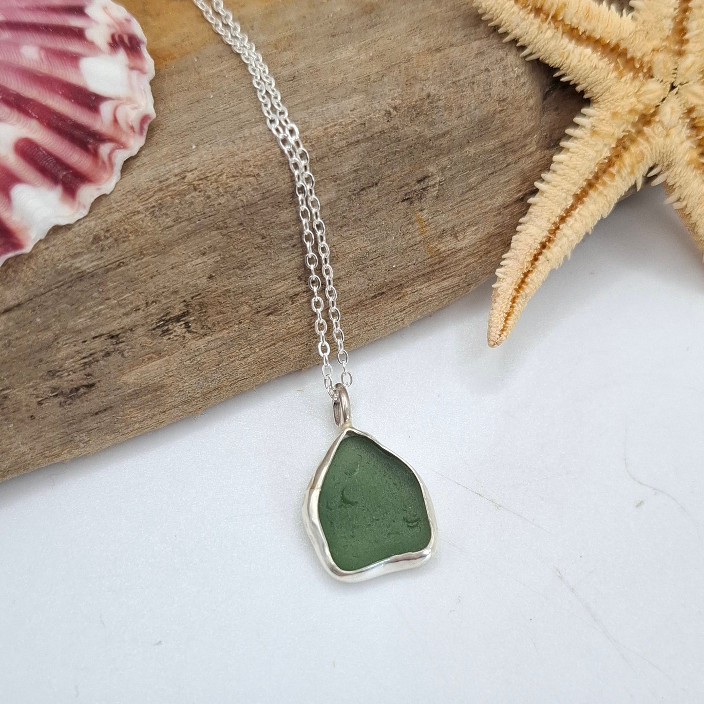 Bright green seaglass pendant on a silver necklace by Shelley Ide Jewellery, showcasing a smooth, polished seaglass pendant.
