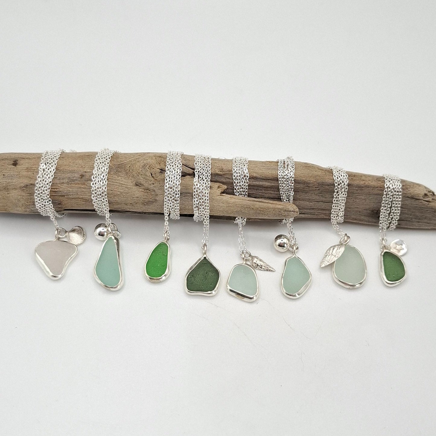 Light aqua blue seaglass pendant and necklace by Shelley Ide Jewelry featuring a smooth, polished seaglass piece on a delicate chain.
