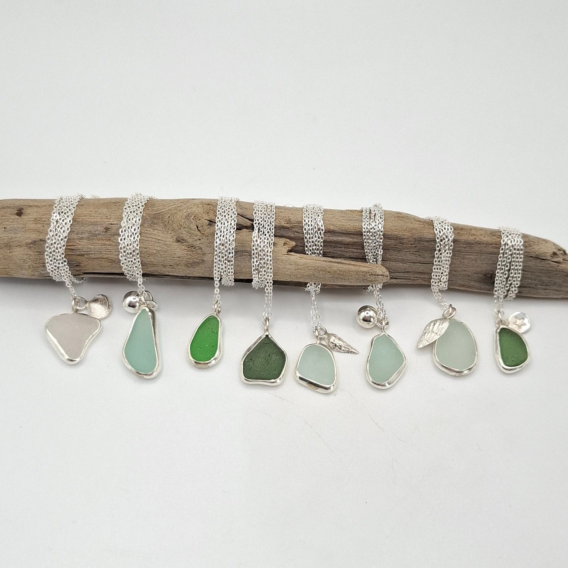 Driftwood with seaglass pieces on a white background