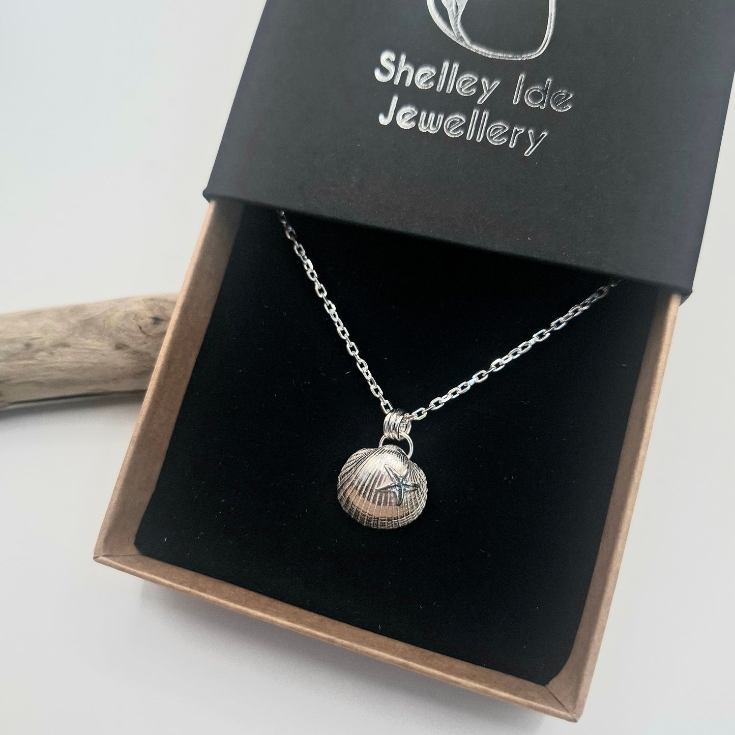 Silver shell pendant necklace in a 'Shelley Ide Jewellery' box on a white background