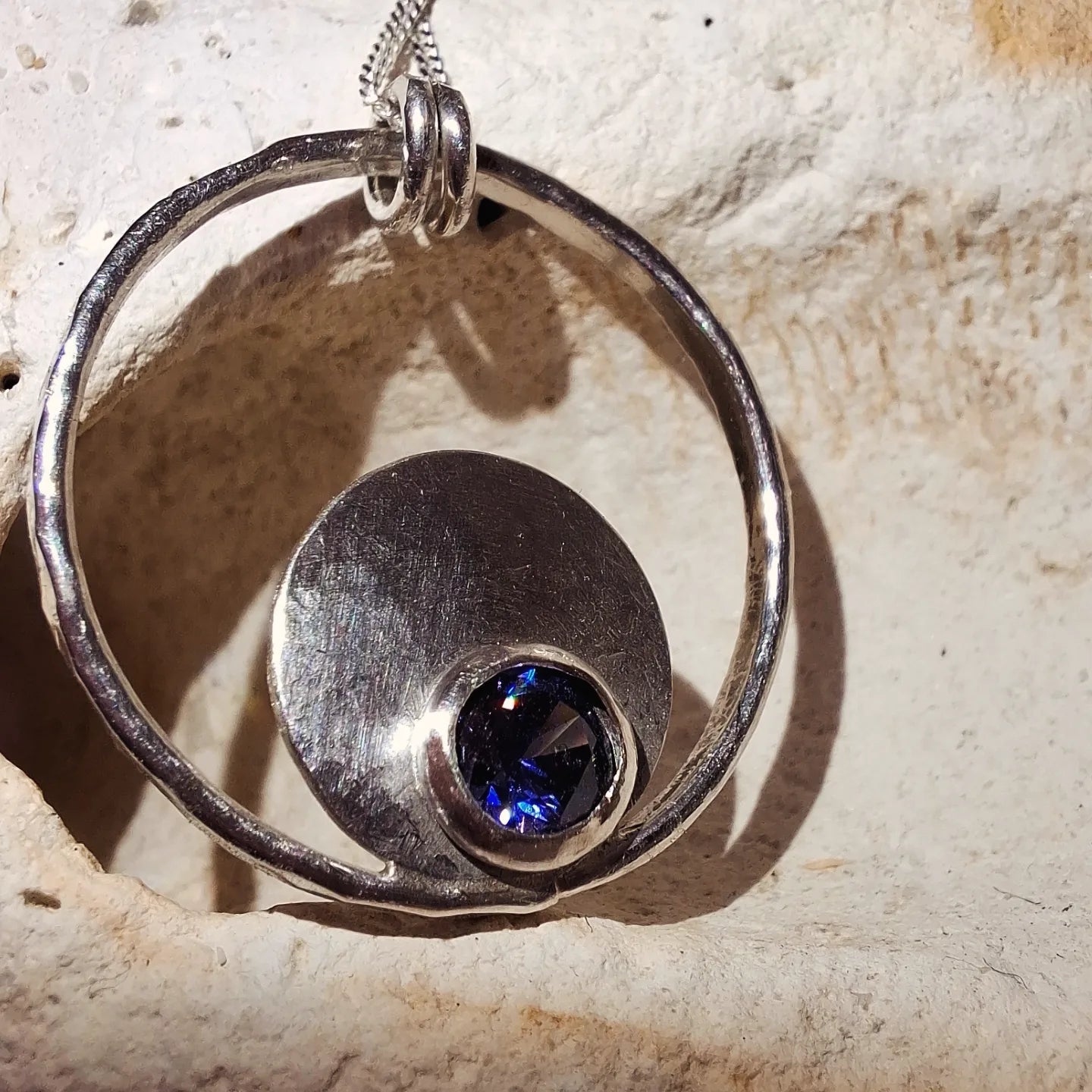 Silver hammered bubbles pendant with tanzanite coloured cubic zirconia and necklace