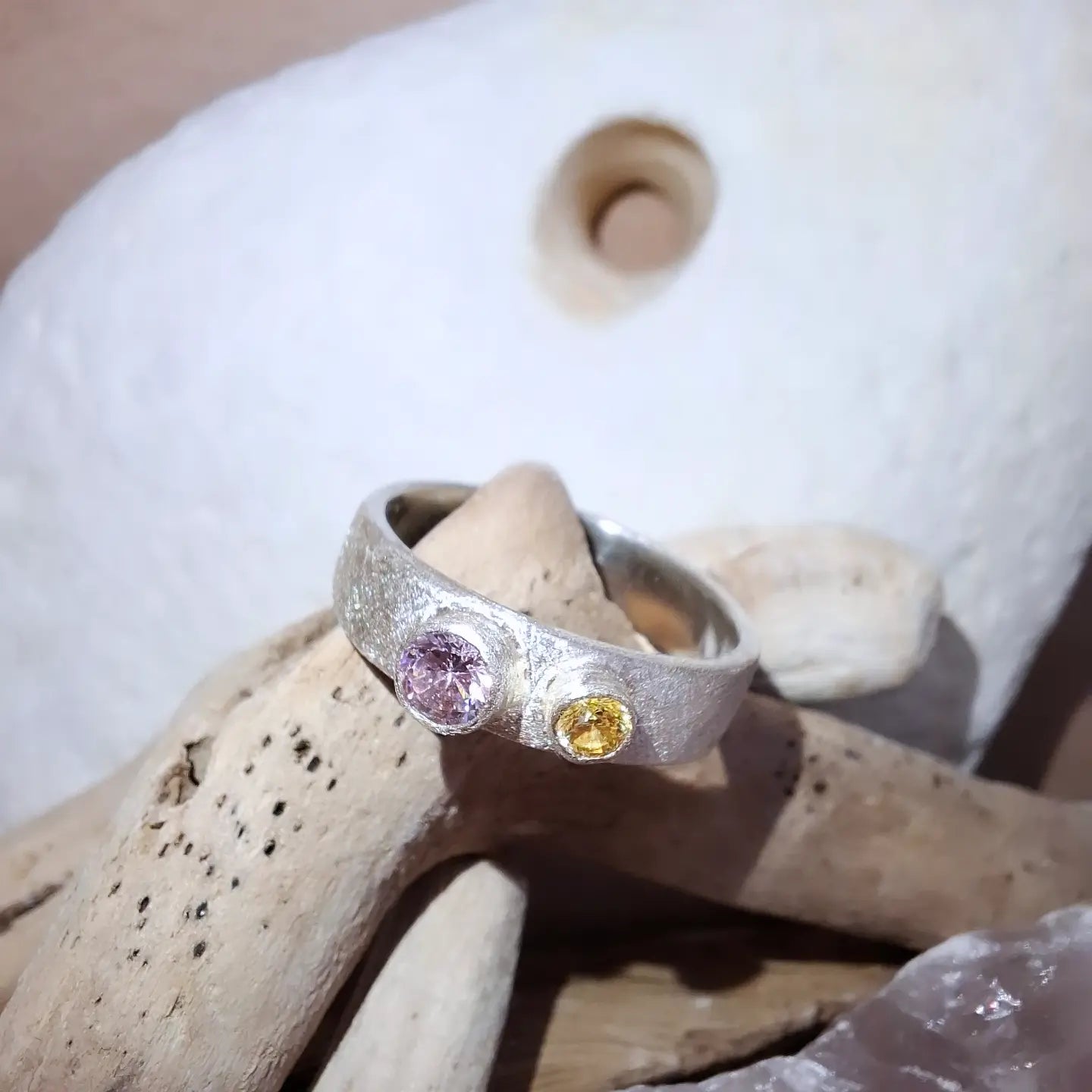 Textured silver ring with rose pink and yellow cubic zirconias.