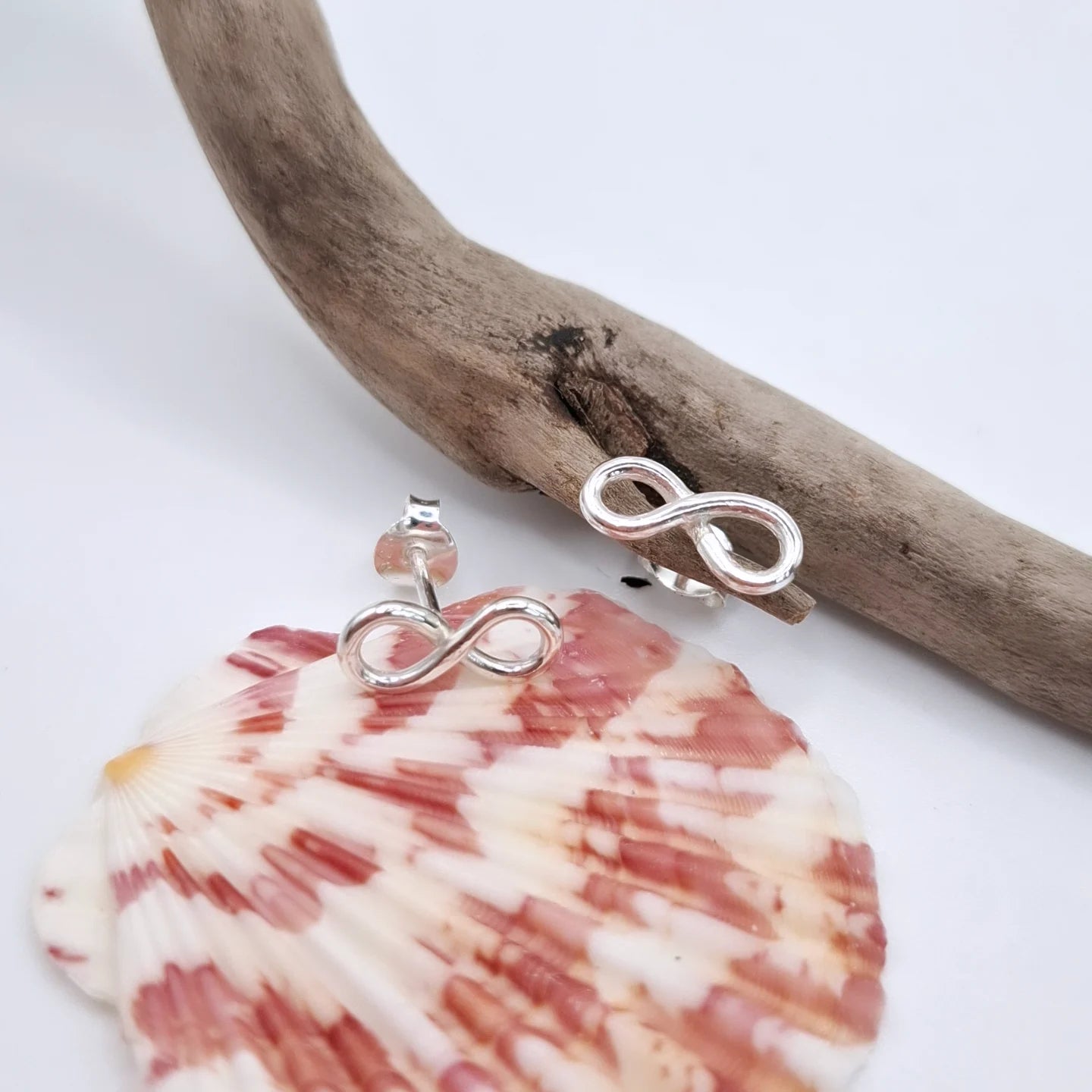 Silver infinity cubic zirconia earring studs by Shelley Ide Jewellery featuring sparkling infinity design and cubic zirconia stones.
